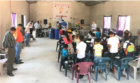 Pastor Maurcio prays over the mission team, the volunteers and children in his congregation in Coyolar